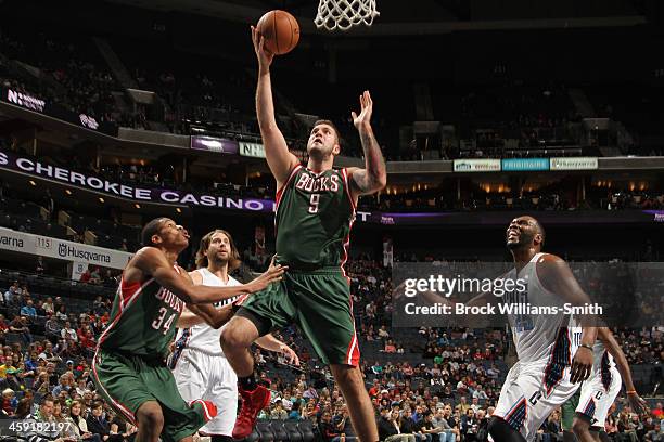 Miroslav Raduljica of the Milwaukee Bucks shoots against the Charlotte Bobcats during the game at the Time Warner Cable Arena on December 23, 2013 in...