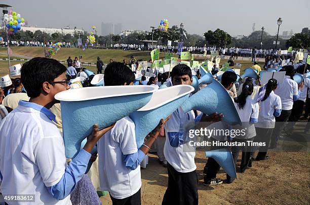 Students carry toilet pot replicas during the International Toilet Festival organised by NGO Sulabh International on the occasion of World Toilet Day...