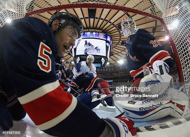 Dan Girardi and Cam Talbot of the New York Rangers defend the net against Jay McClement of the Toronto Maple Leafs during the third period at Madison...