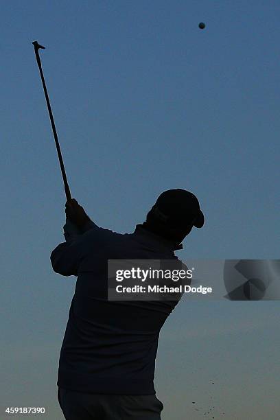 Alistair Presnell of Australia hits an approach shot on the practice fairway ahead of the 2014 Australian Masters at The Metropolitan Golf Course on...