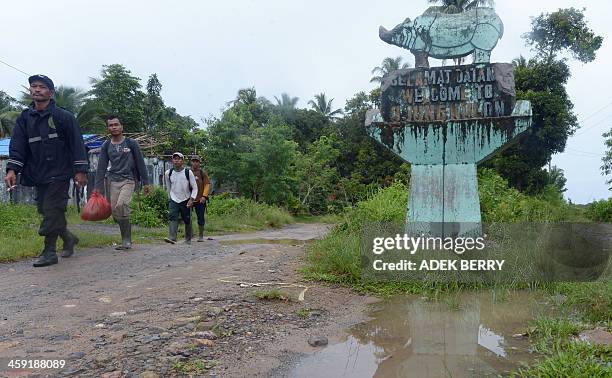 Indonesia-environment-animal-rhino,FEATURE by Arlina Arshad This picture taken on November 16, 2013 shows Indonesian rangers walking past a statue...