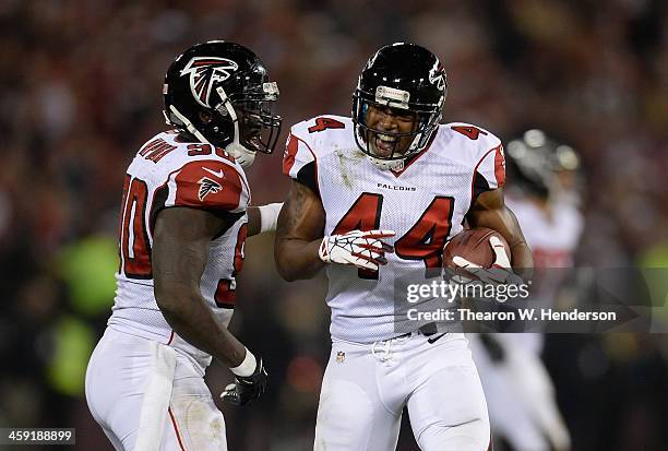 Jason Snelling and Stansly Maponga of the Atlanta Falcons celebrates after Snelling recovered an onside kick against the San Francisco 49ers during...