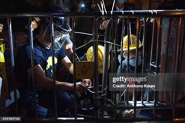 Pro-democracy protesters reinforce barricades with cable ties outside of Legislative Council building on November 19, 2014 in Hong Kong. Hong Kong's...