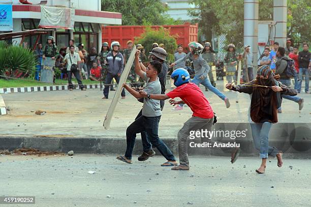 Hundreds students of Makassar State University clash with riot police during a protest against the government decision to cut fuel subsidies in...