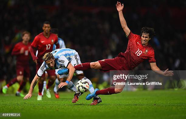 Lucas Biglia of Argentina and Tiago of Portugal battle for the ball during the International Friendly between Argentina and Portugal at Old Trafford...