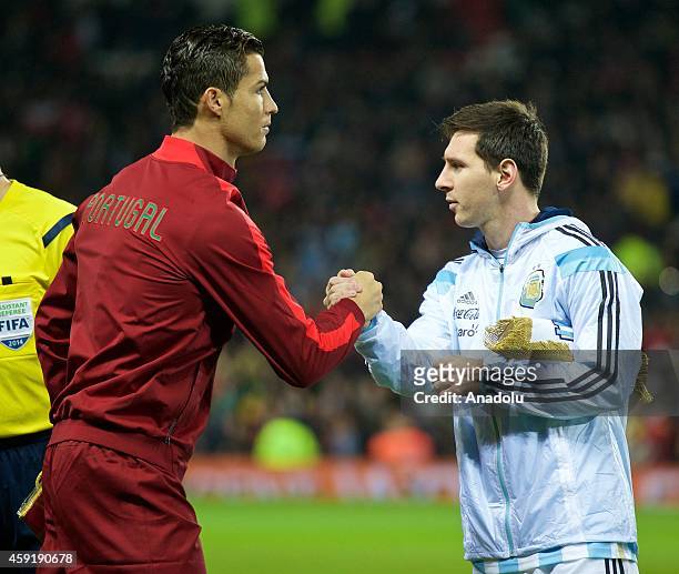Argentina's captain Lionel Messi shakes hand with Portugal's Cristiano Ronaldo before the international friendly football match between Argentina and...