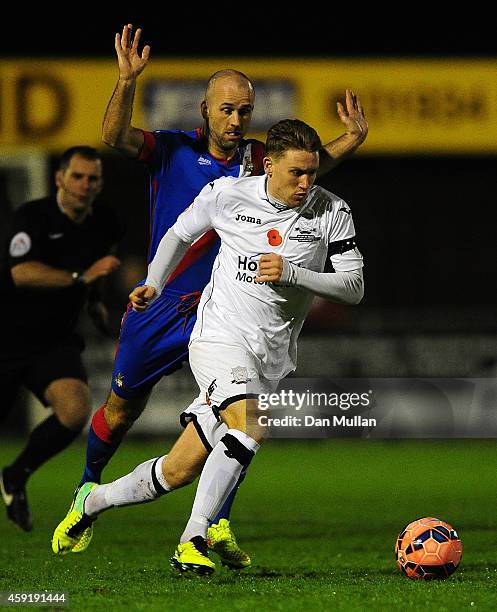 Dayle Grubb of Weston-Super-Mare holds off Paul Keegan of Doncaster Rovers during the FA Cup First Round match between Weston-Super-Mare and...