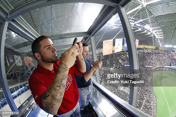 Hector Santiago of the Los Angeles Angels and Jeff Beliveau of the Tampa Bay Rays take photos from the top of the Sapporo Dome before the game...