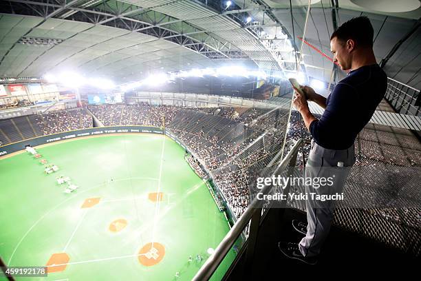 Jeff Beliveau of the Tampa Bay Rays takes a photo from the top of the Sapporo Dome before the game against the Samurai Japan during the Japan...