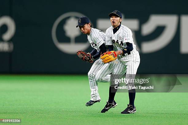 Kenta Imamiya and Ryosuke Kikuchi of the Samurai Japan collide while trying to field a Yasiel Puig of the Los Angeles Dodgers ground ball in the...