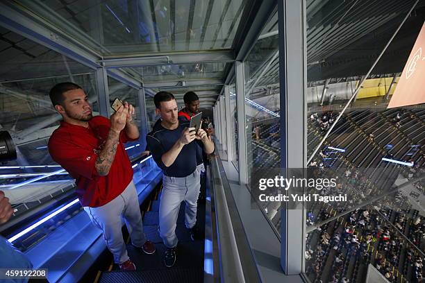 Hector Santiago of the Los Angeles Angels and Jeff Beliveau of the Tampa Bay Rays take photos from the top of the Sapporo Dome before the game...