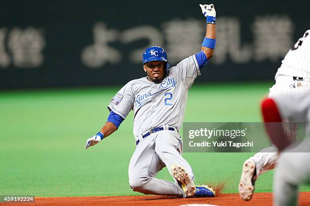 Alcides Escobar of the Kansas City Royals slides into third base on a passed ball in the third inning during the game against the Samurai Japan at...