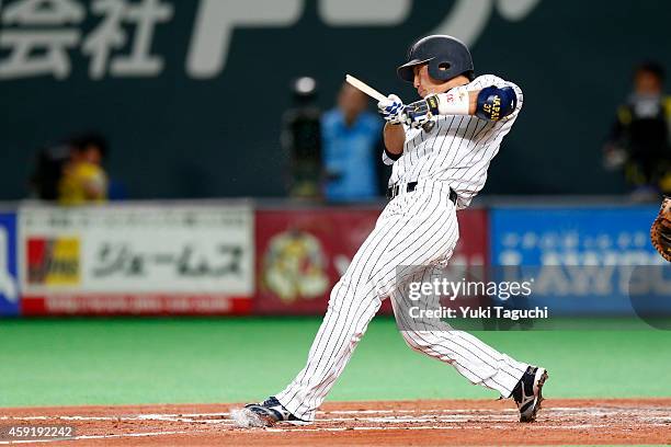 Motohiro Shima the Samurai Japan breaks his bat in the third inning during the game against the MLB All-Stars at the Sapporo Dome during the Japan...