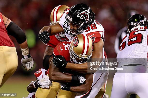 Running back Kendall Hunter of the San Francisco 49ers is tackled by defensive end Cliff Matthews of the Atlanta Falcons during a game at Candlestick...