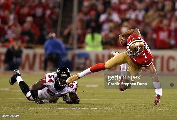 Quarterback Colin Kaepernick of the San Francisco 49ers goes down after being tackled by linebacker Stephen Nicholas of the Atlanta Falcons during a...
