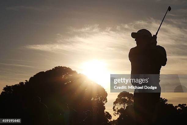 An amateur golfer tees off at sunrise ahead of the 2014 Australian Masters at The Metropolitan Golf Course on November 19, 2014 in Melbourne,...