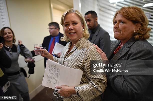 Sen. Mary Landrieu is accompanied by Sen. Heidi Heitkamp after the Senate voted on the Keystone XL Pipeline Bill at the U.S. Capitol on November 18,...