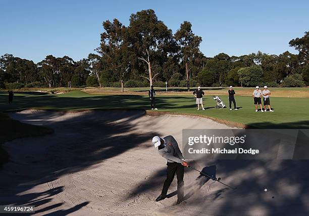 Adam Scott of Australia hits an approach shot out of a bunker during the Pro-Am ahead of the 2014 Australian Masters at The Metropolitan Golf Course...