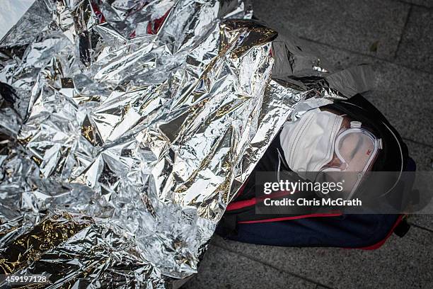 Pro-democracy activist sleeps outside the Legislative Council building after protesters clashed with police on November 19, 2014 in Hong Kong....