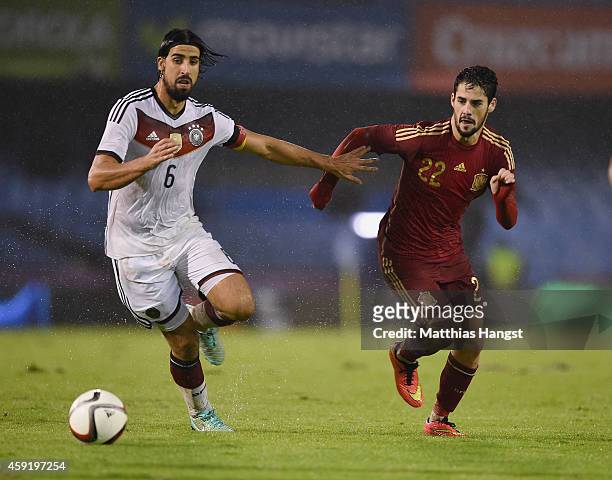 Sami Khedira of Germany and Isco of Spain compete for the ball during the International Friendly match between Spain and Germany at Estadio Balaidos...