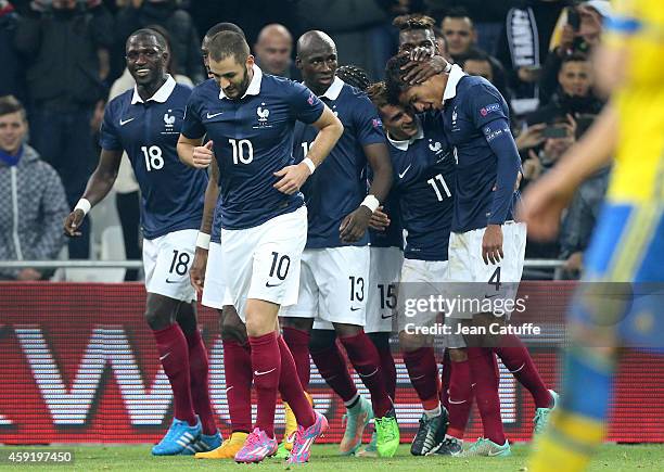 Raphael Varane of France celebrates scoring a goal for his team with teammates during the international friendly match between France and Sweden at...