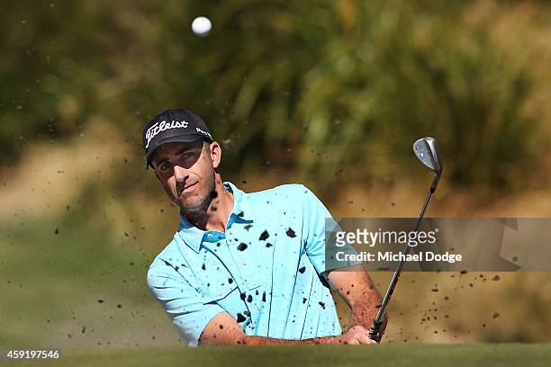 Geoff Ogilvy of Australia hits an approach shot out of a bunker during the Pro-Am ahead of the 2014 Australian Masters at The Metropolitan Golf...