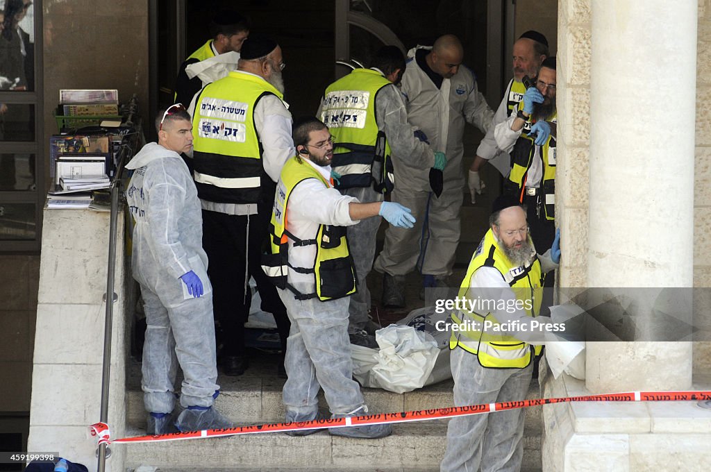 Israeli emergency personnel surrounding the remains from the...