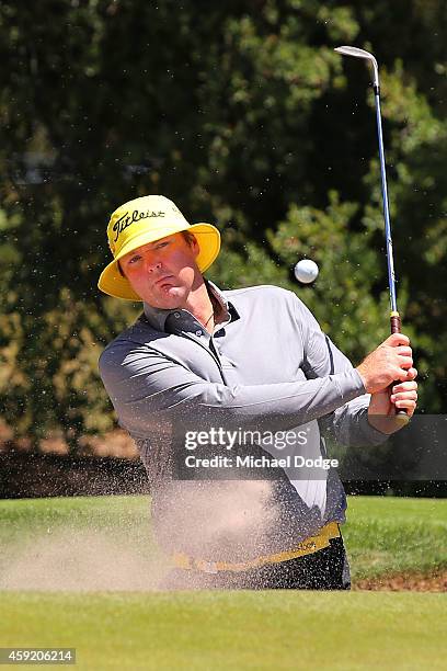 Jarrod Lyle of Australia hits an approach shot form the bunker ahead of the 2014 Australian Masters at The Metropolitan Golf Course on November 19,...