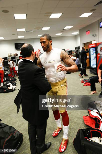 Jed York of the San Francisco 49ers congratulates Colin Kaepernick in the locker room following the game against the New York Giants at Metlife...