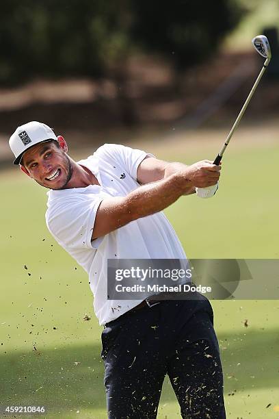 Geelong Cats AFL footballer Tom Hawkins hits an approach during the Pro-Am ahead of the 2014 Australian Masters at The Metropolitan Golf Course on...