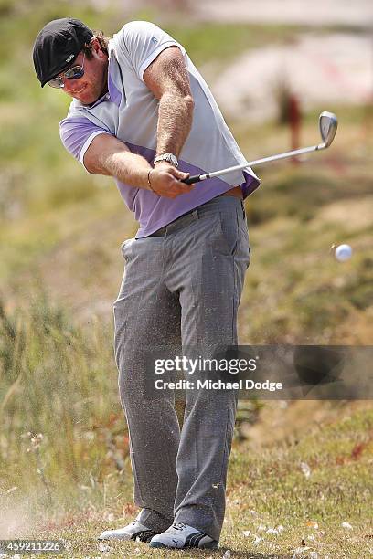 Former AFL footballer Campbell Brown hits an approach shot during the Pro-Am ahead of the 2014 Australian Masters at The Metropolitan Golf Course on...