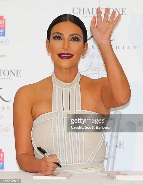 Kim Kardashian waves as she promotes her new fragrance "Fleur Fatale" at Chadstone Shopping Centre on November 19, 2014 in Melbourne, Australia.