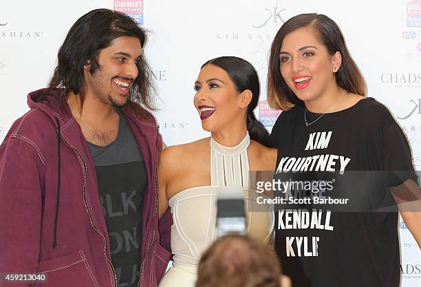 Kim Kardashian poses for a photograph with fans as she promotes her new fragrance "Fleur Fatale" at Chadstone Shopping Centre on November 19, 2014 in...