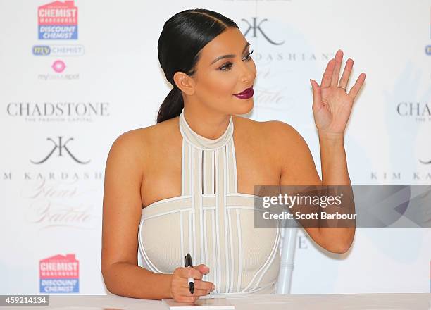 Kim Kardashian waves as she promotes her new fragrance "Fleur Fatale" at Chadstone Shopping Centre on November 19, 2014 in Melbourne, Australia.