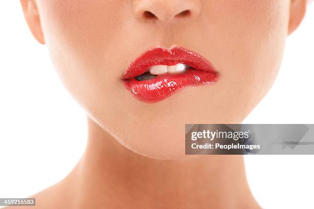 luscious lips - female biting lips stockfoto's en -beelden