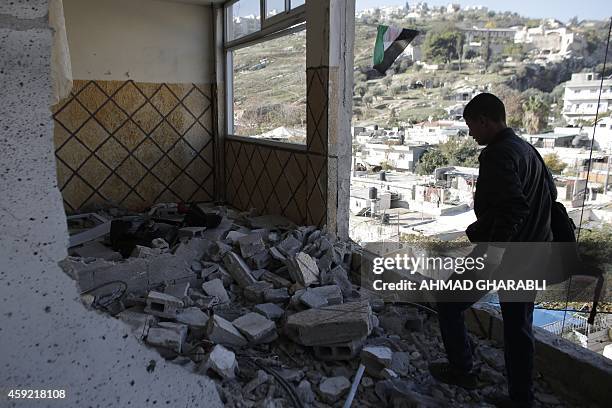 Relative of Abdelrahman Shaludi, a Palestinian who killed two Israelis with his car last month, stands at his family home after it was razed by...