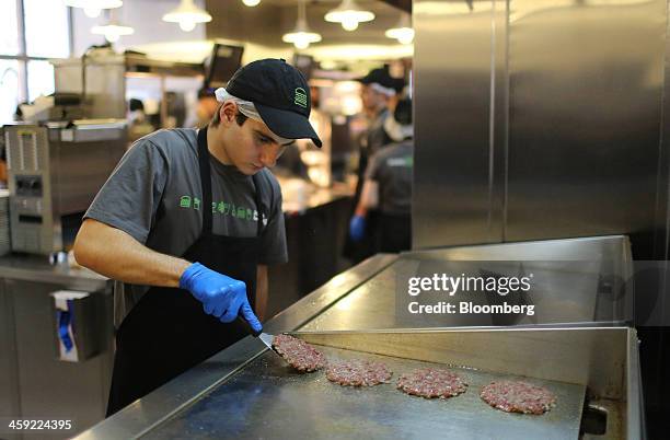 Workers prepare hamburgers in the kitchen of the first Shake Shack burger restaurant to open in Moscow, Russia, on Tuesday, Dec. 24, 2013. The New...