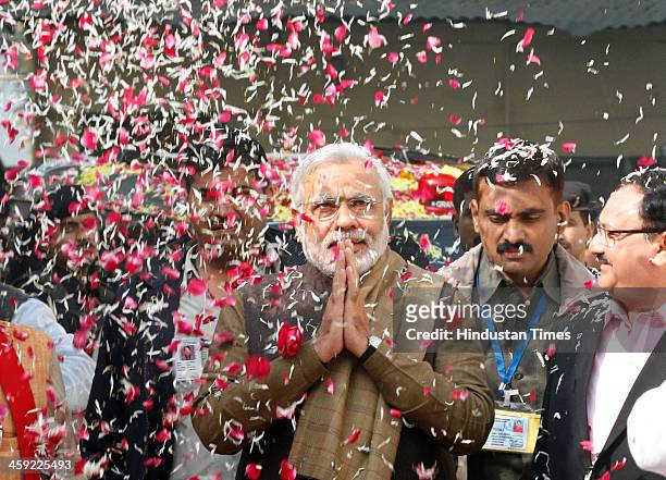 Prime ministerial nominee and Gujarat Chief Minister Narendra Modi is welcomed with flowers for the BJP Chief Minister's conference at the party...