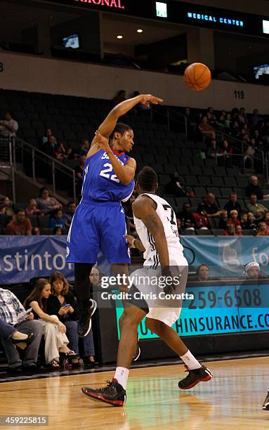 Rodney Williams of the Delaware 87ers passes the ball over Jonathan Simmons of the Austin Toros on December 20, 2013 at the Cedar Park Center in...