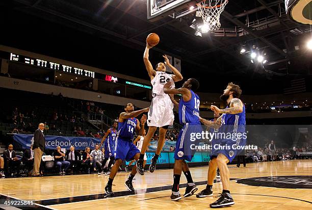 Kyle Hunt of the Austin Toros shoots while being defended by Dustin Salisbery, Damian Saunders and Reeves Nelson of the Delaware 87ers on December...