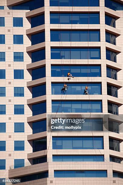 window cleaners - mollypix stock pictures, royalty-free photos & images