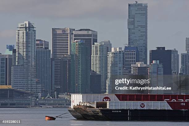 seaspan barges in vancouver harbour and downtown office towers, canada - vancouver harbour stock pictures, royalty-free photos & images