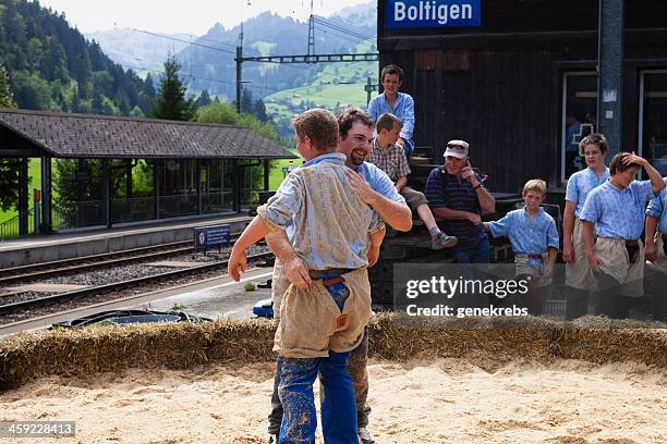 victor wipes sawdust off the back of his opponent - sawdust bale stock pictures, royalty-free photos & images