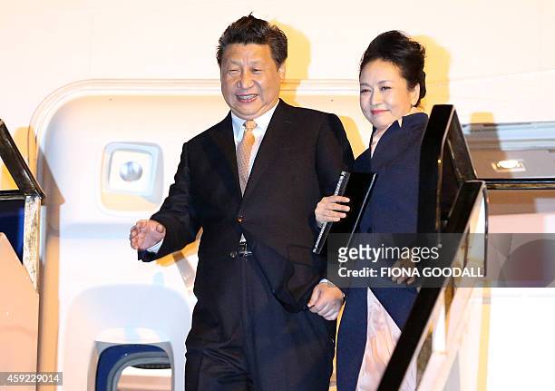 China's President Xi Jinping and his wife Peng Liyuan arrive at Auckland International Airport on November 19, 2014. Xi is on a two day trip to New...