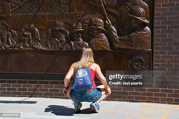 woman at fdny-fire department memorial wall, across from ground zero - women at ground zero stock pictures, royalty-free photos & images