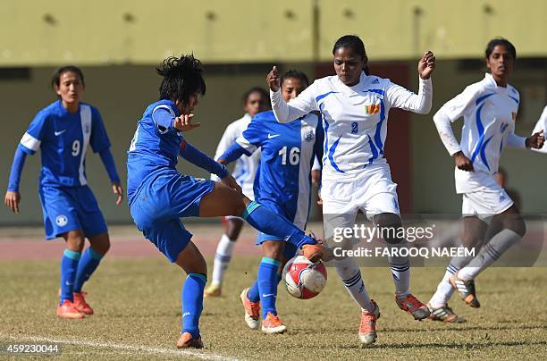 Indian midfielder Ngangom Bala Devi is challenged by Sri Lanka's S.H.C.K Jayarathne during the semi final match between India and Sri Lanka during...