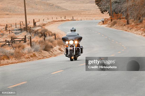 harley on a country road - harley davidson motorcycles stock pictures, royalty-free photos & images