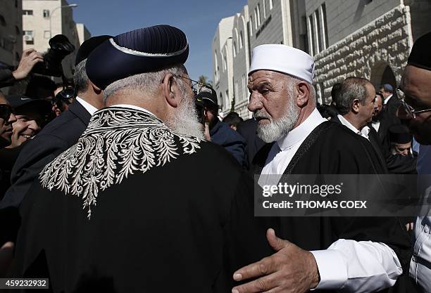 Sephardi Chief Rabbi of Israel Shlomo Amar shakes hands with Arab-Israeli Sheikh Mohammed Kiwan during a visit by chief clerics and representatives...