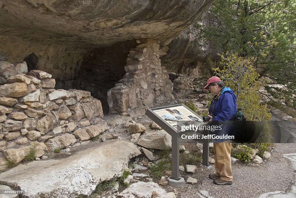 Woman Hiker Viewing an Ancient Cliff Dwelling