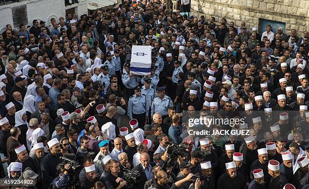 Israeli police officers carry the coffin of their comrade Zidan Saief a member of Israel's Druze minority, during his funeral in his northern home...